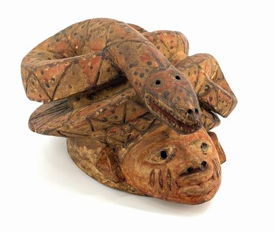 a wooden sculpture of two snakes on top of each other