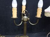 three lamps that are sitting on a table next to each other
