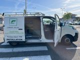 a white van with the door open in a parking lot