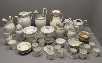 a lot of white and gold china on a table