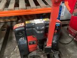 a picture of a red and black machine in a warehouse