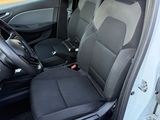 the interior of a white car with black seats and a steering wheel