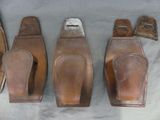four pairs of leather shoes are lined up on a table