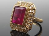 an image of a gold ring with a pink stone surrounded by white diamonds