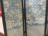 two black folding screen doors with blue and white designs