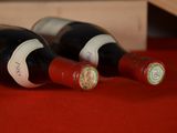 two bottles of wine sitting next to each other on a table