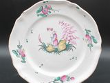 an image of a white plate with pink flowers and birds on it