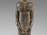 an image of a statue of a man standing with his hands in his pockets