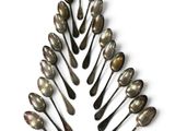many spoons arranged in the shape of a christmas tree