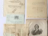 several old papers and papers are on a white surface