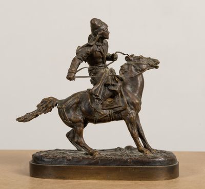 bronze statue of a man on a horse with a bow and arrow