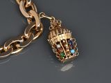 a gold chain with a bird cage charm attached to it
