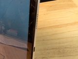 a picture of a broken laptop on a wooden table