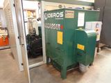 a green machine that is sitting inside of a building