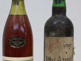 two bottles of wine sitting next to each other on a table