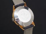 a close up of a watch on a black surface