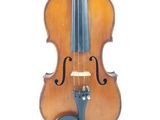 a violin that is sitting on a white surface