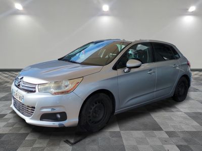 a silver citrole parked on a checkered floor in a garage