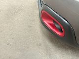 a close up of a car with a red door handle