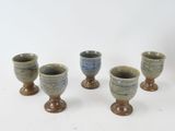 four small cups sitting on top of each other on top of a table