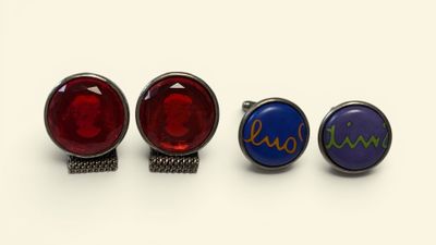 three pairs of cufflinks with the names of three different countries