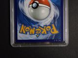a pokemon card in a plastic holder on a table