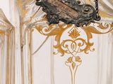 a glass vase with a gold decoration on it