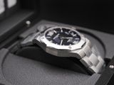 a watch sitting in a box on a black surface