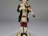 une image représentant une figurine d'un homme tenant un violon