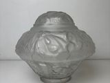 a glass jar with a lid on a white surface