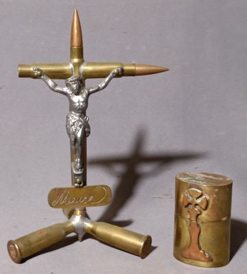 a statue of jesus on a cross next to a lighter