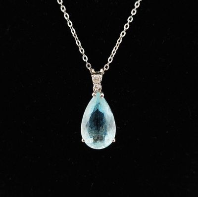 a necklace with a blue tear shaped stone on a silver chain