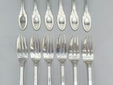 a lot of forks and spoons that are on a table