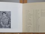 an open book with a drawing of a woman on it