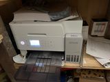 a printer that is sitting on a shelf in a room