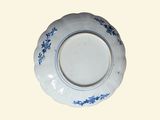 a blue and white plate with blue flowers on it