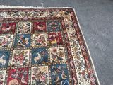 a rug on the floor with a cat sitting on it