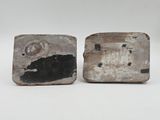 two pieces of wood are sitting next to each other on a white surface