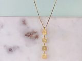 a gold plated necklace with the word ' love ' written on it
