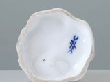 a small white bowl with a blue design on it
