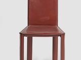 the back of a red leather chair with a wooden frame