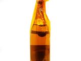 a glass bottle with a liquid inside of it on a white surface