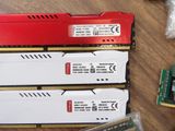 two red and two white ram modules sitting on top of a wooden table