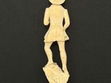 a carved ivory figurine of a woman in a hat and dress