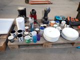 many plates and cups on a pallet with other items
