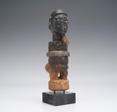 a wooden statue of a man with a hat on his head