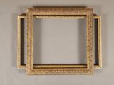 an old picture frame hanging on a wall in a room