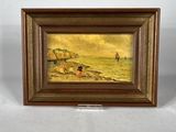 une peinture à l'huile représentant une scène de plage, dans un cadre en bois