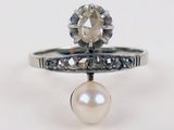 a picture of a ring with a pearl and a diamond