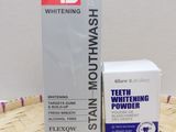 whitening toothpaste and a box of toothpaste sitting on a bamboo mat